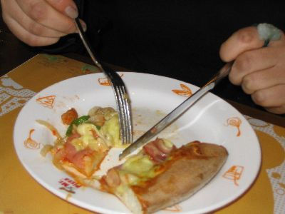 Fat Man Eating Pizza. Eating your pizza with a knife