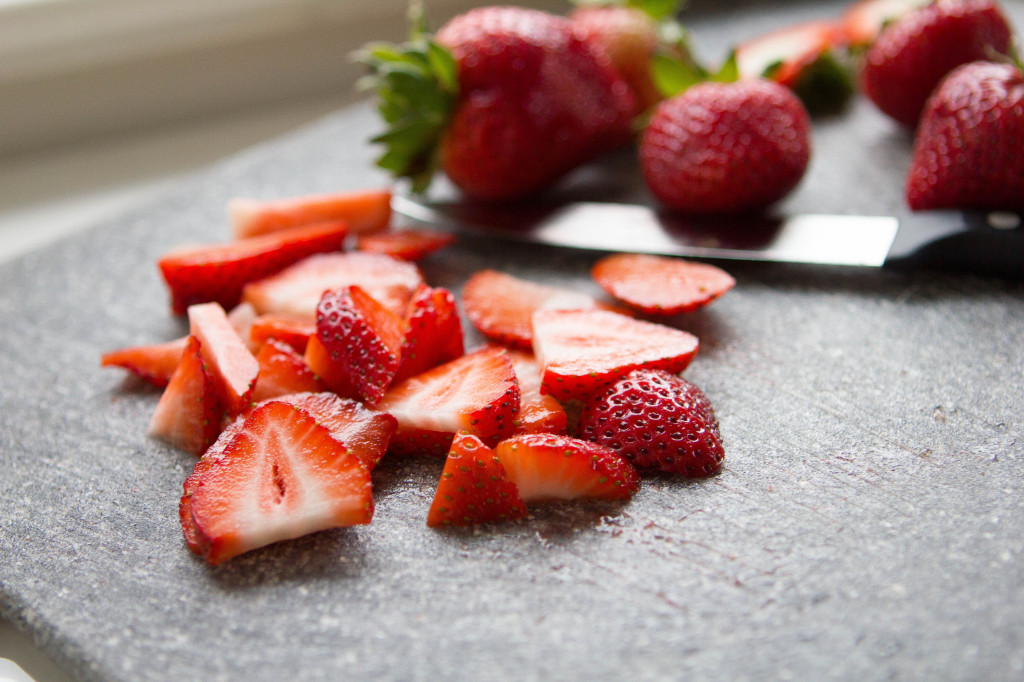 chopped strawberries cutting board