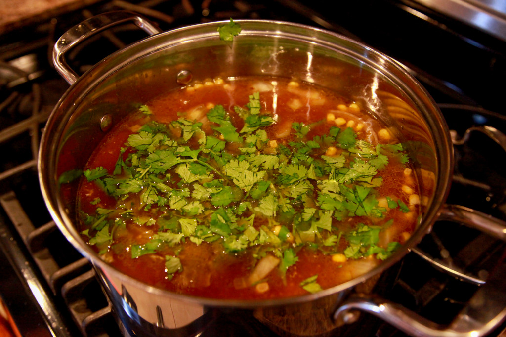 adding ingredients to chicken and broth