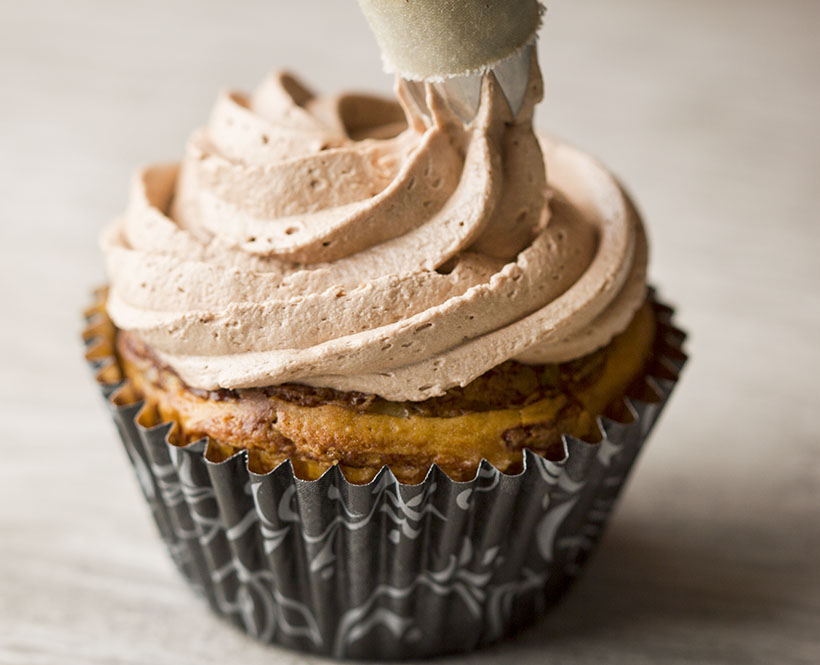 piping-frosting-onto-nutella-cupcake