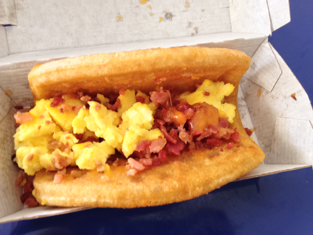 Taco Bell Breakfast Waffle Taco with Bacon inside close up