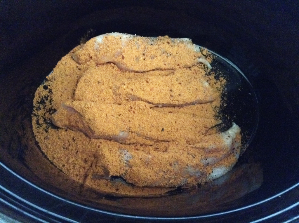 Crock Pot Fajitas chicken covered in taco seasoning